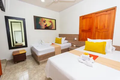 a hotel room with two beds and a mirror at Hotel Buddha Mystic By Del Toro in Doradal