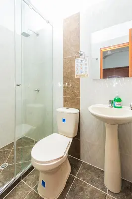 a bathroom with a toilet and a sink and a shower at Hotel Buddha Mystic By Del Toro in Doradal