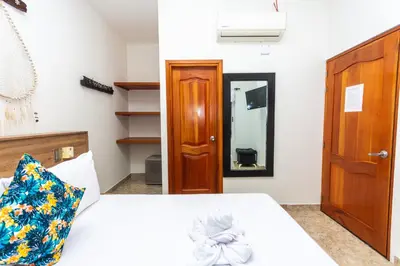 a bedroom with a bed and a mirror at Hotel Buddha Mystic By Del Toro in Doradal