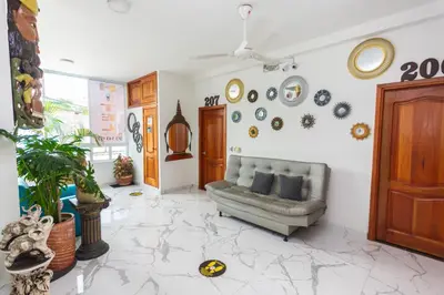 a living room with a couch and plates on the wall at Hotel Buddha Mystic By Del Toro in Doradal