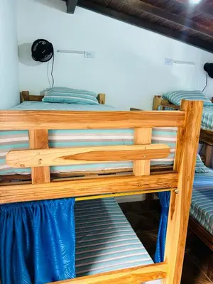 a wooden bunk bed in a room at Blue Coast Hostal in Medellín