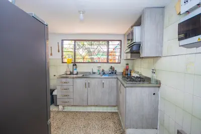 a small kitchen with a sink and a window at Blue Coast Hostal in Medellín