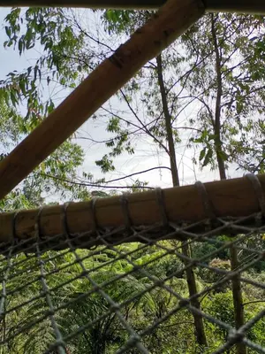 a close up of a fence with trees in the background at Sukha Glamping in Rionegro