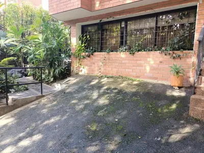 a house with a brick wall and a driveway at Aparta Hotel LOFT Campestre Jacuzzi Poblado apt 107 in Medellín