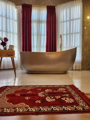 a large tub sitting in the middle of a bathroom at Hotel Mansion Sant Serrant Medellín- Aeropuerto Rionegro in Marinilla