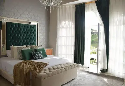 a bedroom with a large bed with a large window at Hotel Mansion Sant Serrant Medellín- Aeropuerto Rionegro in Marinilla