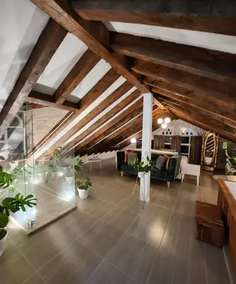a large living room with wooden ceilings and plants at Hotel Mansion Sant Serrant Medellín- Aeropuerto Rionegro in Marinilla