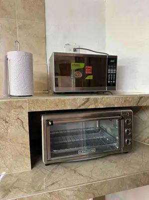 a microwave and a toaster oven on a counter at increible casa de campo con piscina y jacuzzi! in Támesis