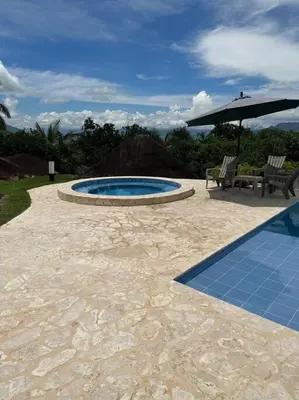 a patio with a pool and a bench and an umbrella at increible casa de campo con piscina y jacuzzi! in Támesis