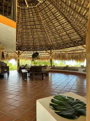 a restaurant with a table and a straw roof at increible casa de campo con piscina y jacuzzi! in Támesis