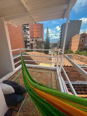 a hammock on the balcony of a building at La Posada de Miguel in Medellín
