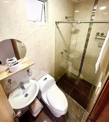 a bathroom with a toilet and a sink and a shower at La Posada de Miguel in Medellín