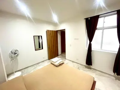 a room with a bed and a window at La Posada de Miguel in Medellín