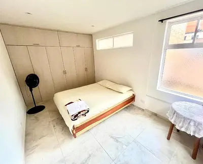 a small bedroom with a bed and a window at La Posada de Miguel in Medellín