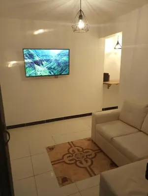 a living room with a couch and a flat screen tv at Apartamento acogedor en Medellín in Medellín