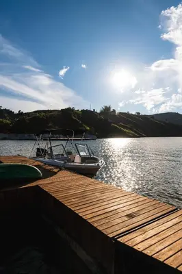 a boat is docked at a dock on a lake at 5CHALETS in Guatapé