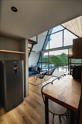 a room with a table and chairs and a large window at 5CHALETS in Guatapé