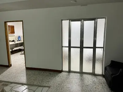 an empty room with sliding glass doors in a room at Casa Blanca Hostal in Rionegro