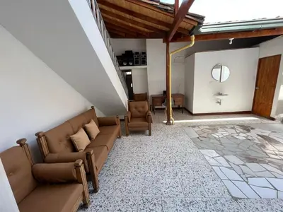 a living room with two couches and a mirror at Casa Blanca Hostal in Rionegro