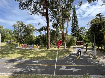 a person riding a bike in a parking lot with a stop sign at Casa Blanca Hostal in Rionegro