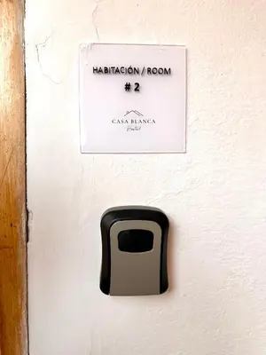 a wall with a mailbox on the wall at Casa Blanca Hostal in Rionegro