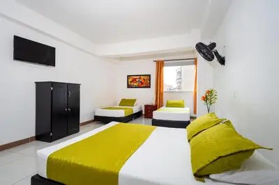 a bedroom with a large bed with a yellow blanket at Ayenda 1234 Imperio 70 in Medellín