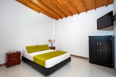 a bedroom with a bed and a flat screen tv at Ayenda 1234 Imperio 70 in Medellín