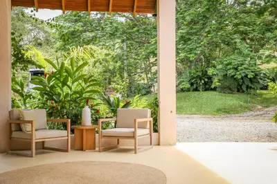 a porch with two chairs and a table and a view at Hotel Tahiti in Puente Iglesias