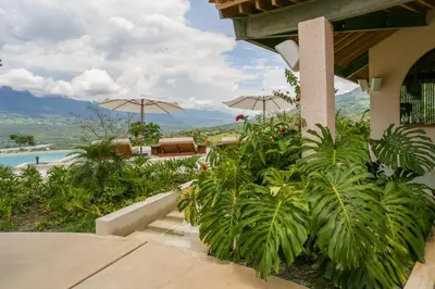 a resort with plants and umbrellas and a pool at Hotel Tahiti in Puente Iglesias