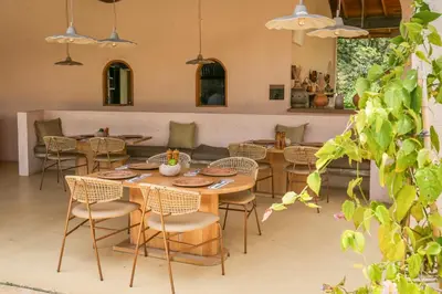 a dining room with tables and chairs in a room at Hotel Tahiti in Puente Iglesias