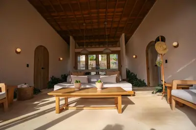 a living room with a couch and a table at Hotel Tahiti in Puente Iglesias