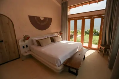 a bedroom with a bed and a large window at Hotel Tahiti in Puente Iglesias