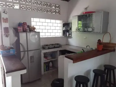 a kitchen with a refrigerator and some stools in it at Hospedaje casa completa Honda Tolima in Honda