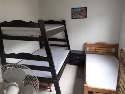 a room with two bunk beds and a fan at Hospedaje casa completa Honda Tolima in Honda