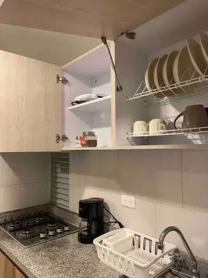 a kitchen with a sink and a stove top oven at Apartamento nuevo centro histórico! in Manizales