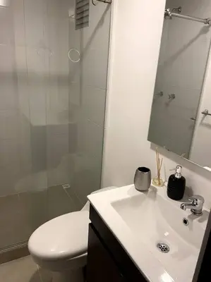 a bathroom with a toilet and a sink and a shower at Apartamento nuevo centro histórico! in Manizales