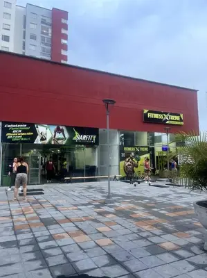 a large red building with people standing outside of it at Apartamento nuevo centro histórico! in Manizales