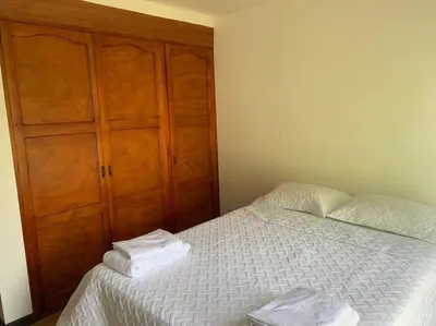 a bedroom with a bed with two towels on it at Hermosa casa de campo en ambiente tranquilo. in Rionegro
