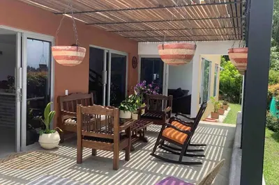 a patio with chairs and a table and potted plants at Hermosa casa de campo en ambiente tranquilo. in Rionegro