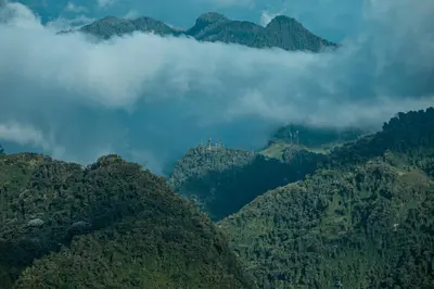 a group of mountains with clouds in the background at Tierra Mágica eje cafetero in Manizales