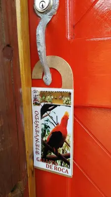 a red door with a picture of a bird on it at Hotel Kantarrana Urbana Jardin in Jardin