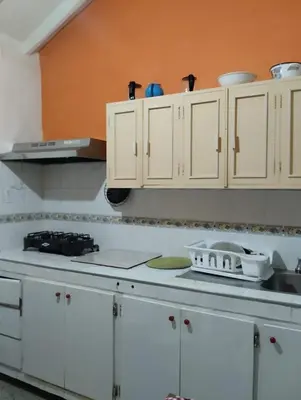 a kitchen with white cabinets and a sink at Casa Mamá Chelita in Titiribí