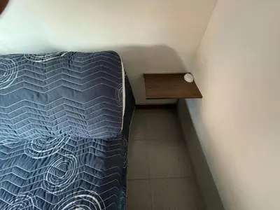 a bedroom with a bed and a wooden table at Vacaciones con tu mascota Loft con terraza Mayorca in Sabaneta