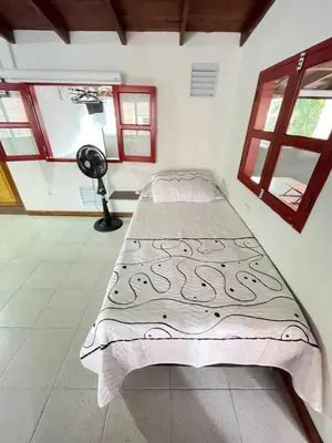 a bedroom with a bed in a room with windows at Vacaciones con tu mascota Loft con terraza Mayorca in Sabaneta
