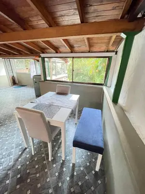 a dining room with a table and chairs and a laptop at Vacaciones con tu mascota Loft con terraza Mayorca in Sabaneta