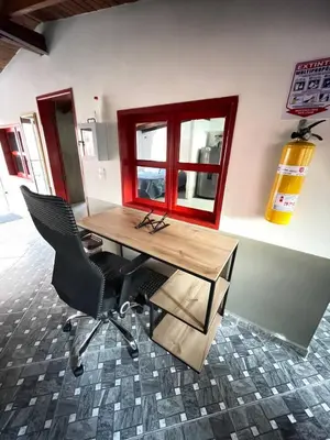 an office with a desk and two chairs and a window at Vacaciones con tu mascota Loft con terraza Mayorca in Sabaneta