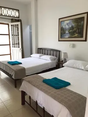 a bedroom with two beds with towels on them at CASAQUINTA PRIVADA MARIQUITA-TOLIMA in Mariquita
