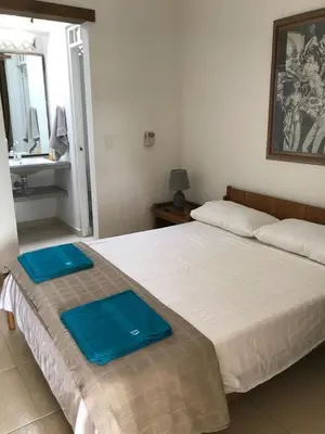 a bedroom with two beds with blue trays on them at CASAQUINTA PRIVADA MARIQUITA-TOLIMA in Mariquita