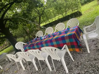 a group of white chairs and a table with a blanket at CASAQUINTA PRIVADA MARIQUITA-TOLIMA in Mariquita