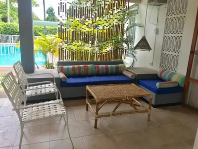 a living room with a couch and chairs and a chandelier at CASAQUINTA PRIVADA MARIQUITA-TOLIMA in Mariquita